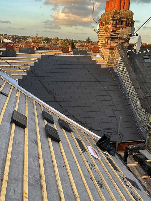 A pitched roof having new tiles fitted